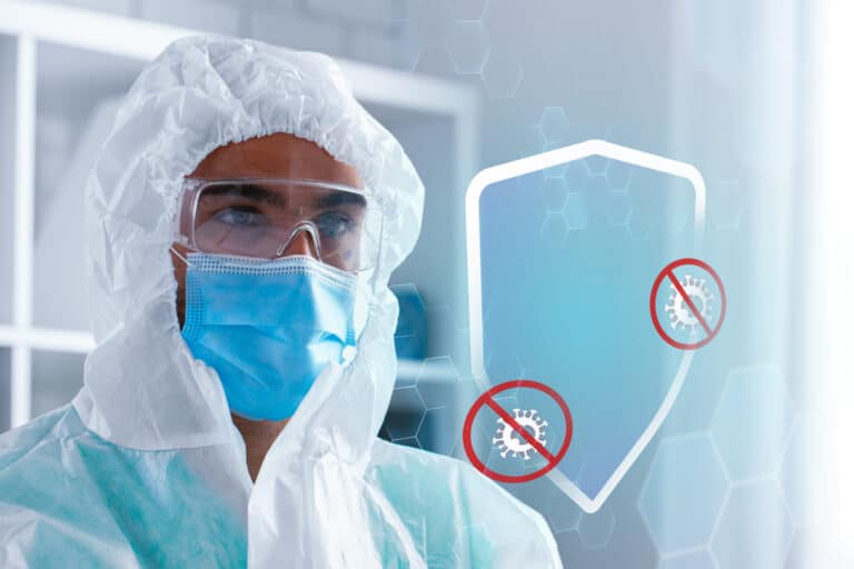 Medical professional in protective gear examines virus prevention measures indoors